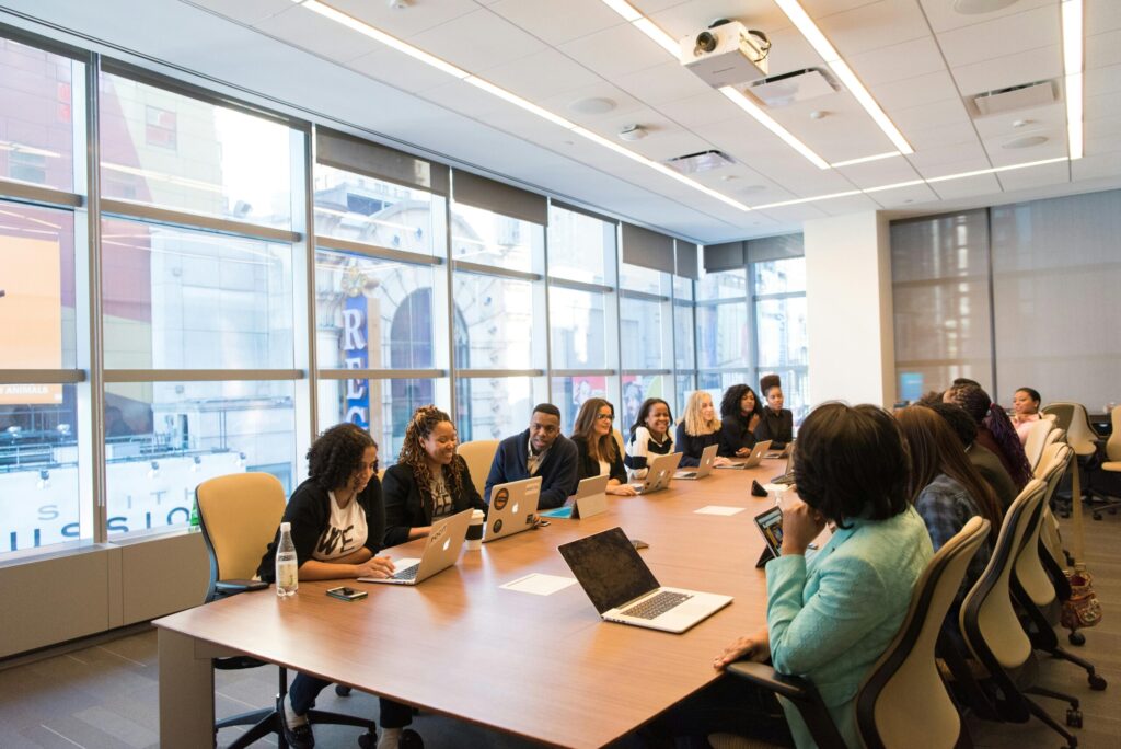 pexels-photo-1181406-1181406 A diverse team of business professionals collaborating in a modern meeting room.